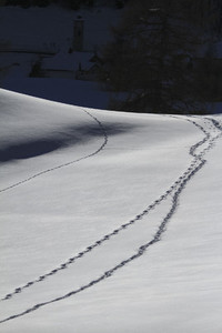 Tracks on snowy mountain slope