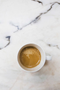 View from above espresso in mug on marble surface