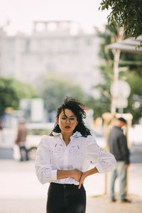 Portrait confident stylish woman on sidewalk
