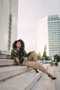 Portrait confident  stylish woman on urban steps