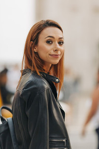 Portrait confident young woman in leather jacket