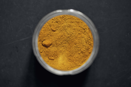 View from above turmeric powder in spice jar