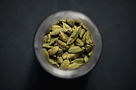 View from above cardamom seeds in spice jar
