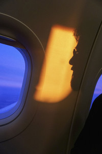 Shadow of man against airplane window