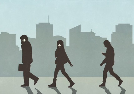 Pedestrians walking and using smart phones in city