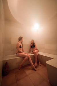Two young women enjoying hammam or turkish bath