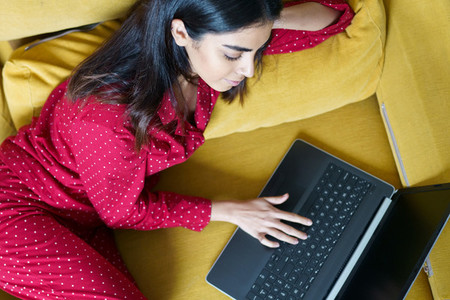 Persian woman at home using laptop computer