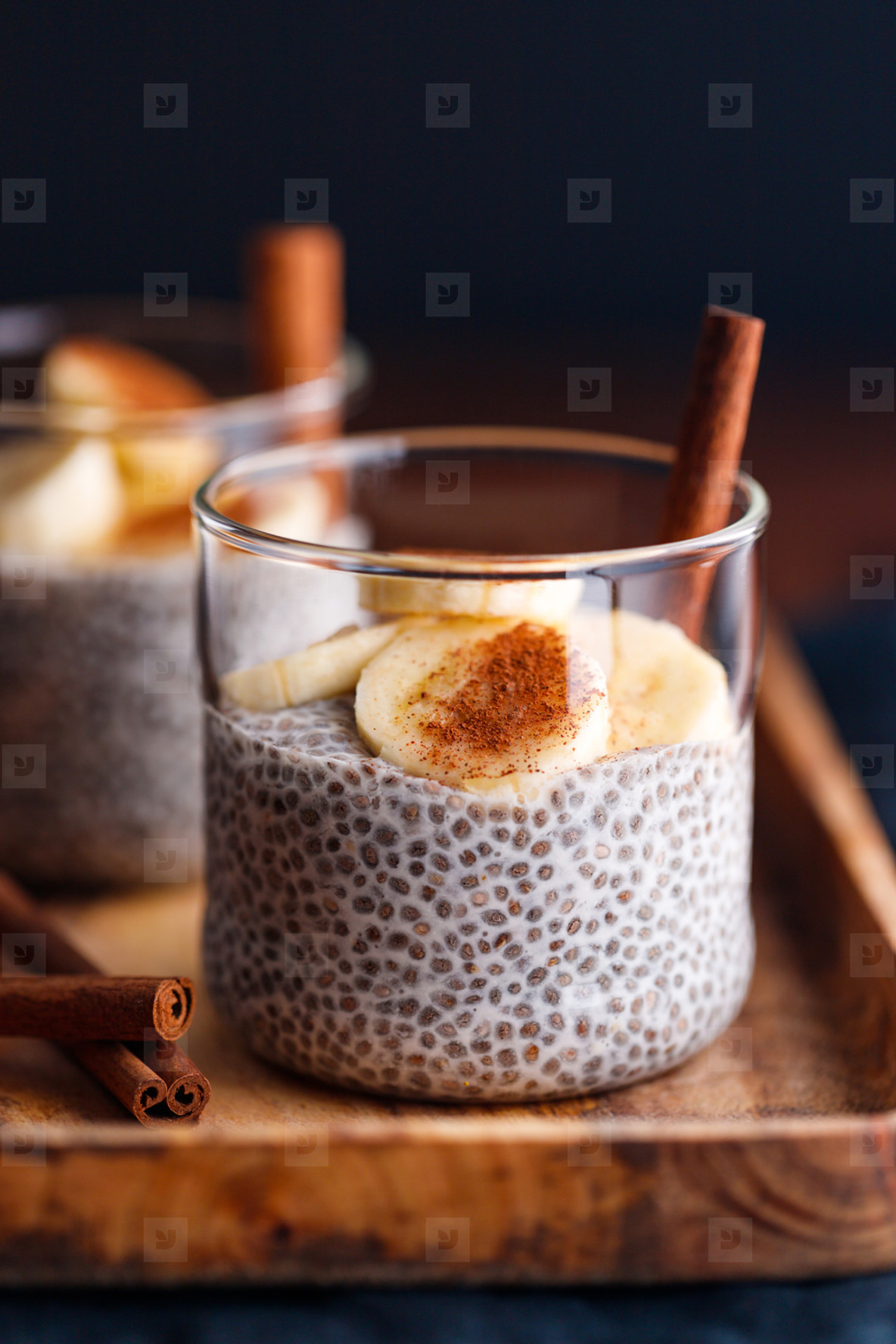 Chia pudding with coconut milk and banana in glasses on a table Vegetarian healthy dessert