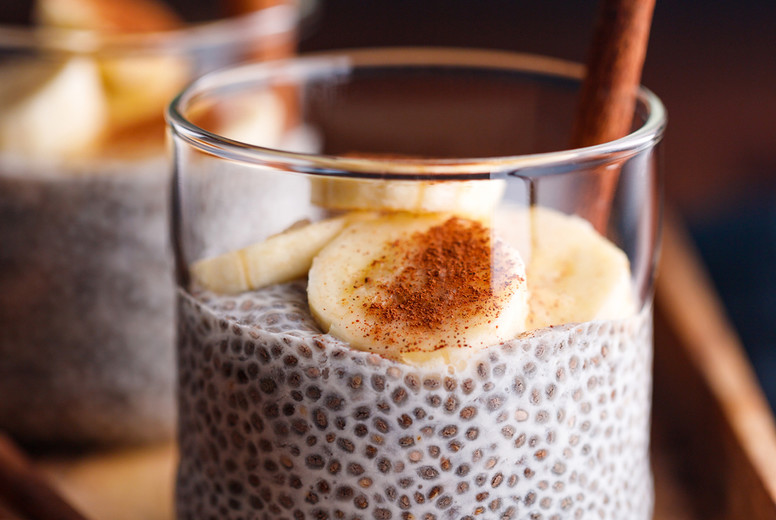 Chia pudding with coconut milk and banana in glasses on a table. Vegetarian healthy dessert.