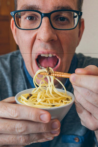 Man eating spaghetti and crickets