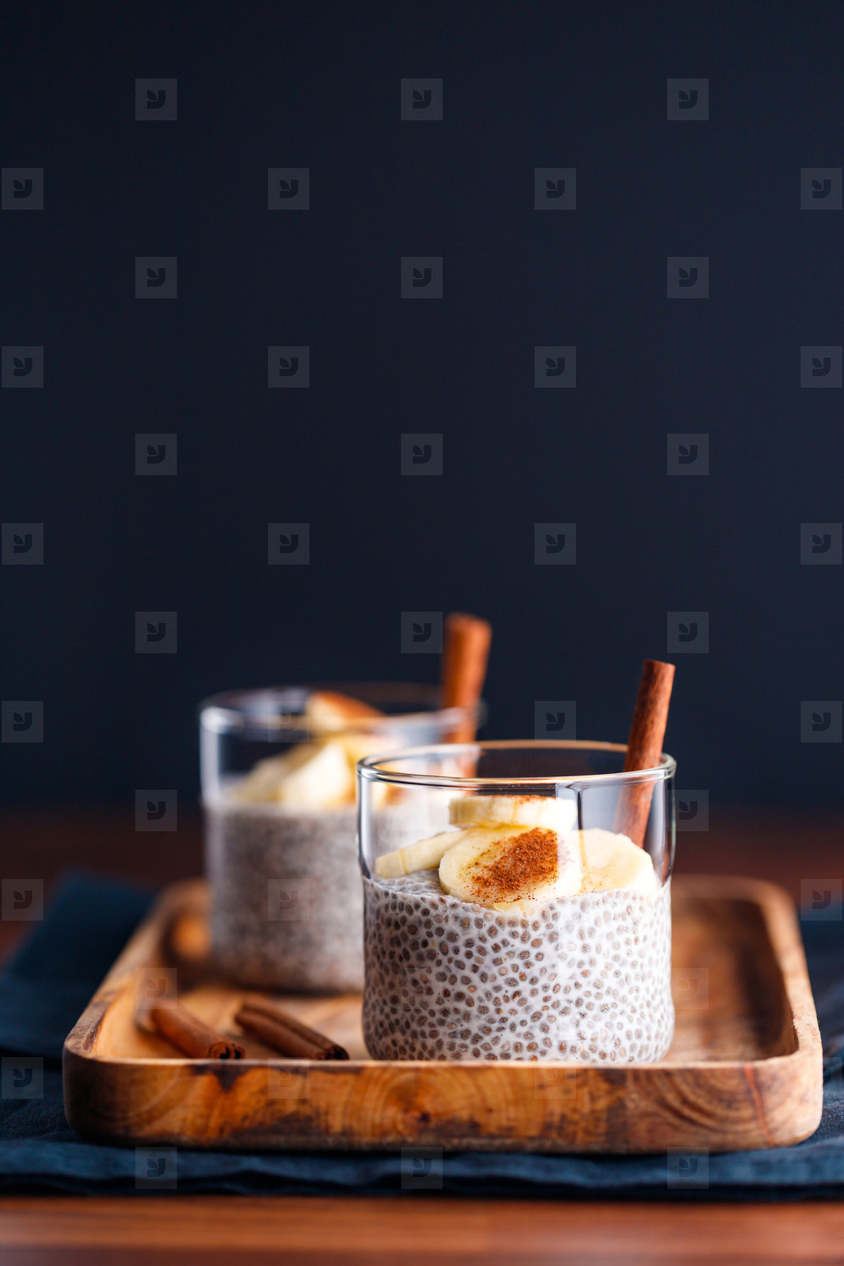 Chia pudding with coconut milk and banana in glasses on a table  Vegetarian healthy dessert