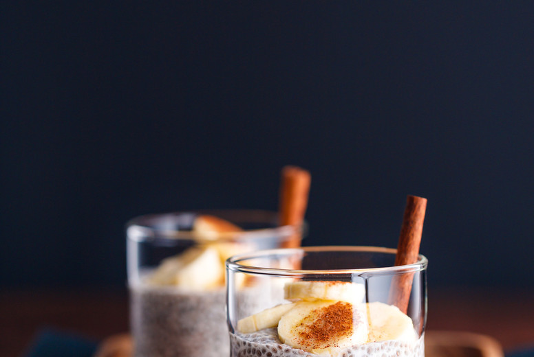Chia pudding with coconut milk and banana in glasses on a table. Vegetarian healthy dessert.