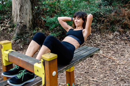 Sportswoman training on an abdominal bench