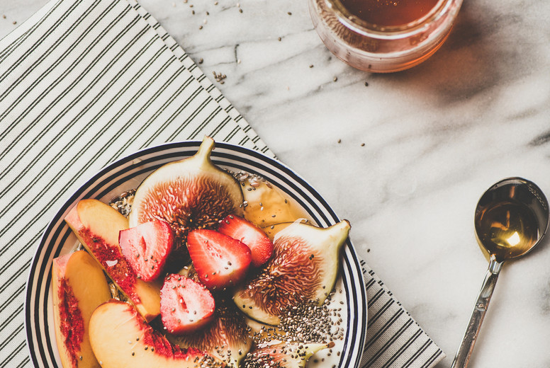 Healthy vegetarian breakfast bowl with yogurt, fruits and honey
