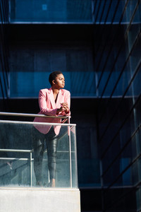 African businesswoman standing near business office building