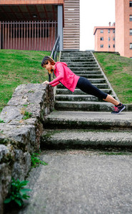 Female athlete doing push ups outdoors