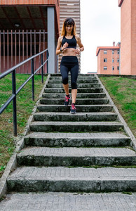 Female athlete going down stairs outdoors