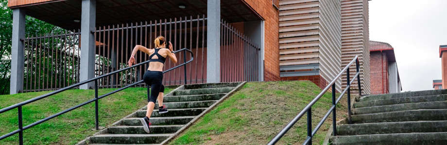 Female athlete climbing stairs outdoors