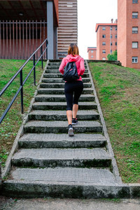 Female athlete going up stairs outdoors