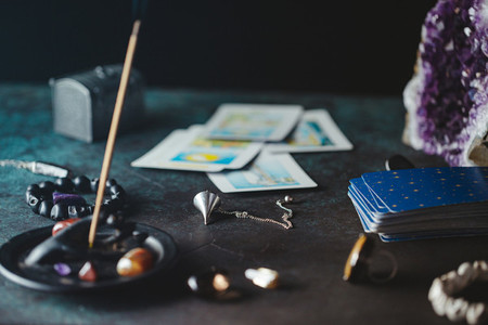 Tarot cards are surrounded magic things on a table Mystical and occult concept