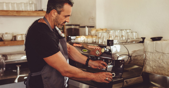 Barista making coffee with a machine