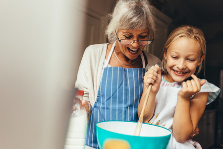 Granny and kid having fun in kitchen