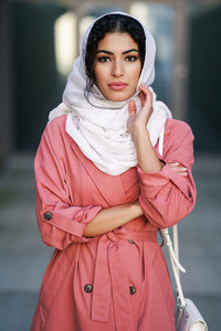 Young Arab woman wearing hijab headscarf walking in the city center