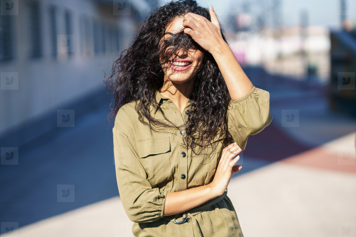 Arab Woman with curly hair in her face stock photo (199640) - YouWorkForThem