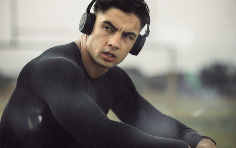 Man relaxing after workout in rainy morning