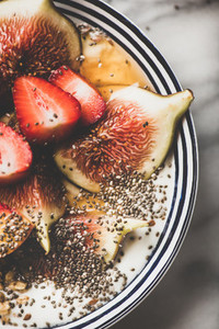 Healthy detox breakfast bowl with yogurt  fruits and honey  close up