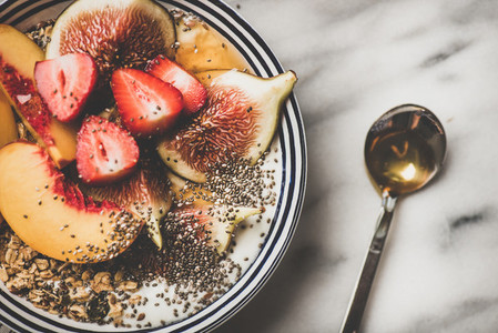 Healthy vegetarian breakfast bowl with yogurt fruits and honey close up