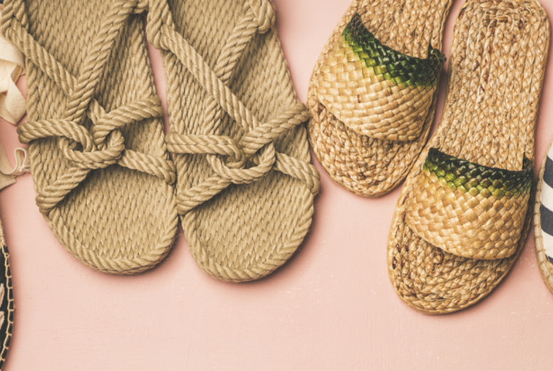 Variety of trendy summer shoes over pink background, wide composition