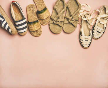 Variety of trendy summer shoes over pink background  copy space