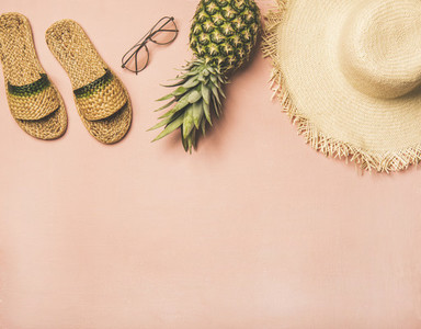 Variety of summer apparel items and fresh pinapple  copy space