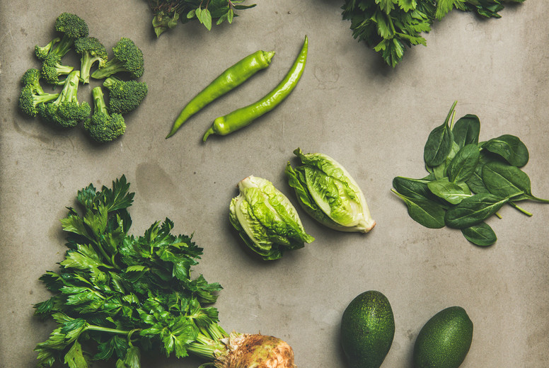 Healthy vegan salad ingredients layout over concrete table background