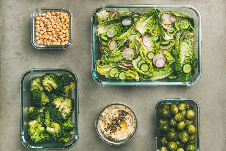 Healthy vegan or vegetarian dishes in containers, vertical composition