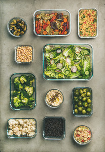 Healthy vegan or vegetarian dishes in containers vertical composition