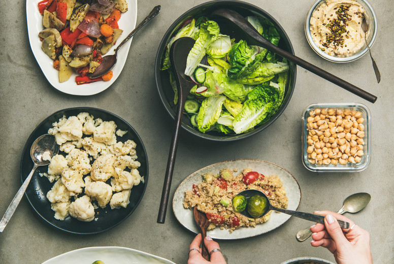 Healthy vegan dishes and woman hands taking couscous, squqre crop
