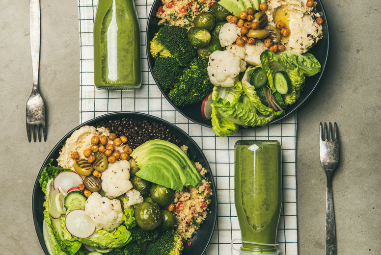Flat-lay of healthy dinner with superbowls and smoothies, square crop