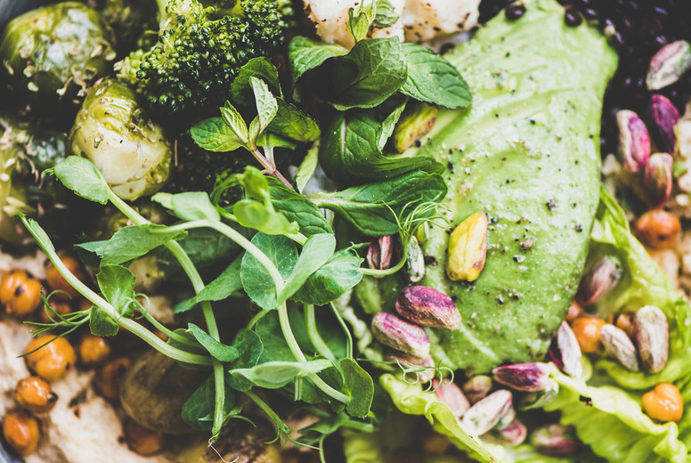 Healthy vegan superbowl and green smoothie on table
