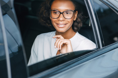 Smiling businesswoman in car