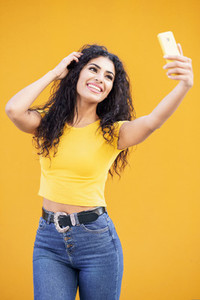 Young Arab woman taking selfie photograph with smartphone