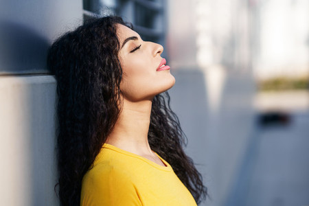 Arab woman with eyes closed in urban background
