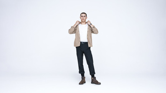 Young man standing against white background