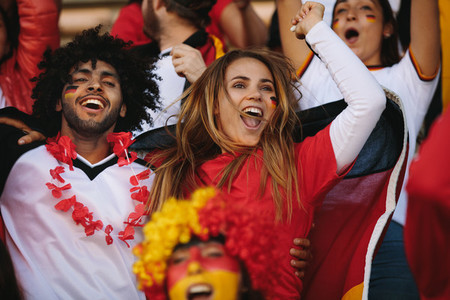German spectators in stadium cheering their national team