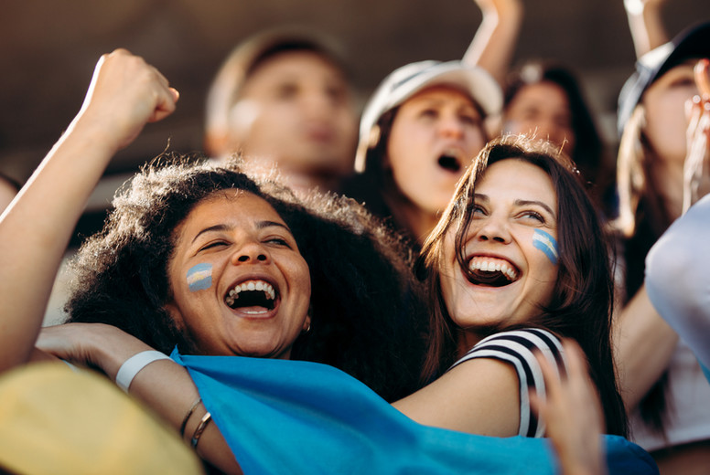 Excited crowd of sports fans celebrating their teams victory