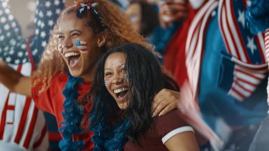 Group of American soccer fans cheering in fan zone