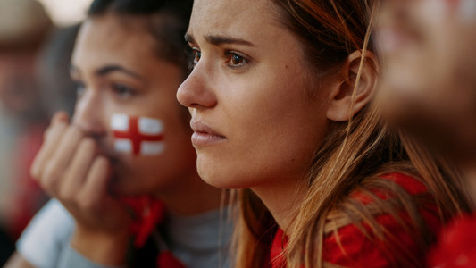 English sports fans looking upset during a football game