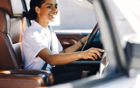Woman driver touching dashboard