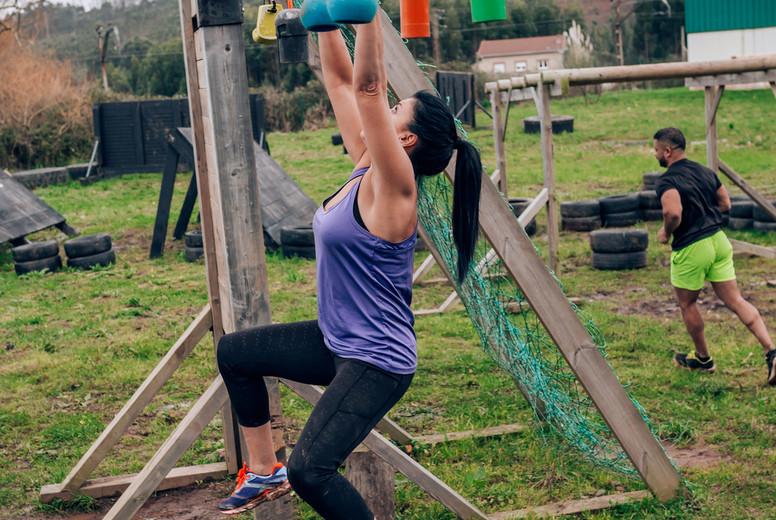 Participant obstacle course doing suspension